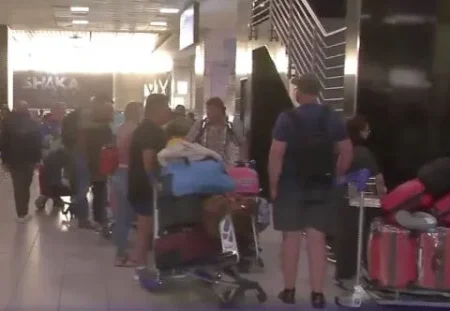 Group of Afrikaner refugees at airport preparing to board chartered flight leaving South Africa for the United States.
