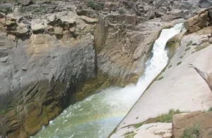 Surging Augrabies Falls attracts tourists with its powerful, record-breaking water flow in South Africa.