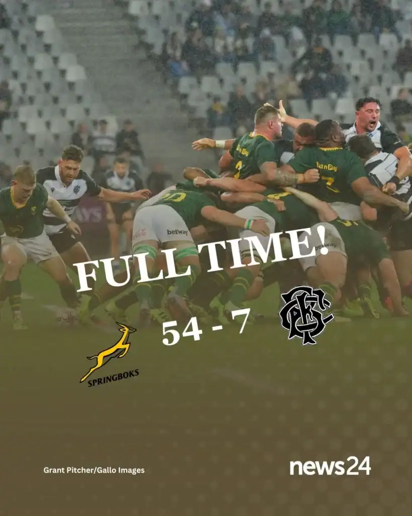 Springboks celebrating a try against the Barbarians in the cold, rainy Cape Town match.