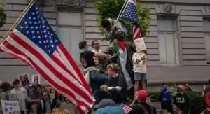 Protesters with "No Kings" signs oppose Trump's military parade in Washington D.C.