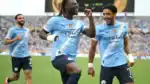 Manchester City players wearing new Puma kits celebrating after signing £1 billion kit deal.