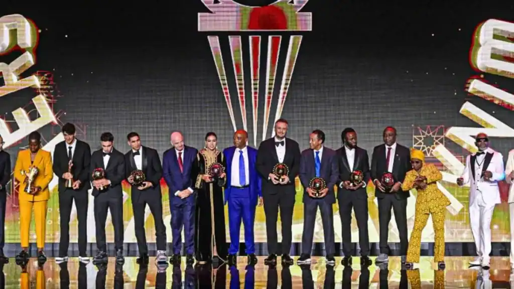 Achraf Hakimi and Ghizlane Chebbak holding their CAF Player of the Year 2025 awards in Rabat.