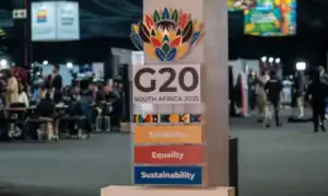 President Ramaphosa at G20 closing ceremony next to an empty chair symbolizing the US absence.