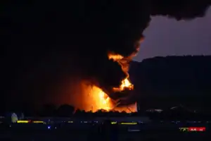 Emergency crews respond to UPS Flight 2976 Louisville plane crash site during NTSB investigation.