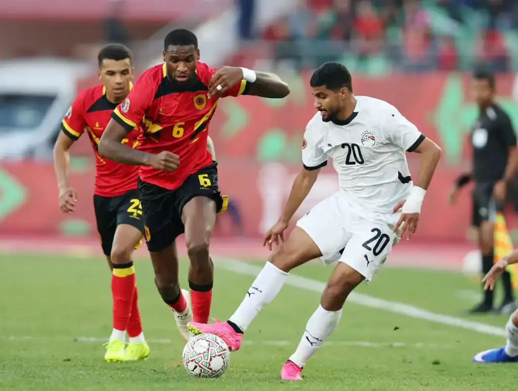 Angola and Egypt players battling for possession in the AFCON 2025 group stage match.