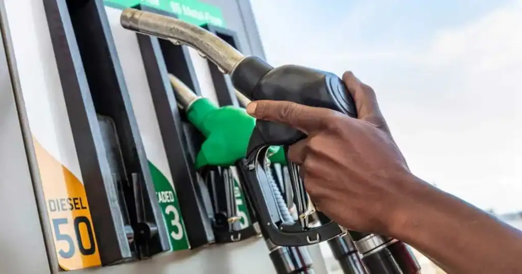 Petrol pump nozzle at a South African filling station displaying price increase for December 2025.