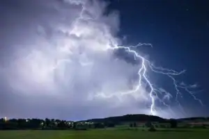 Heavy storm clouds over KZN coast indicating flooding risk and severe weather warnings.