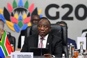 US flag and G20 logo illustrating South Africa's exclusion from the 2026 G20 Sherpa meeting.