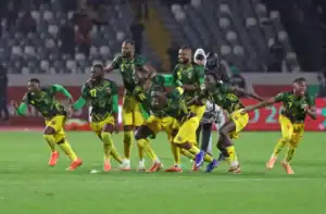 Mali players celebrate after ten-man Mali defeat Tunisia on penalties to book quarter-final place.