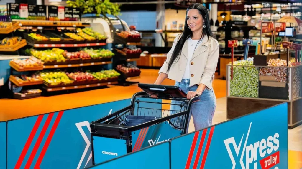 Checkers smart trolley in action at a Cape Town store showing the XtraSavings scan-and-pay screen.