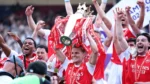 Arsenal players celebrate lifting the Premier League trophy after beating Crystal Palace 2-1