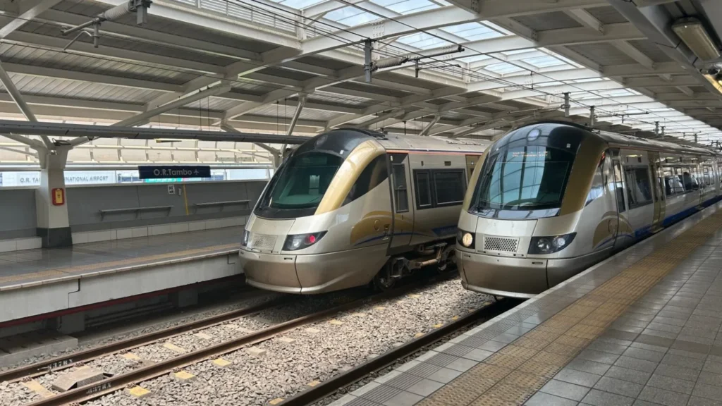 Gold Gautrain branded Gau Express e-hailing vehicle driving on a road in Gauteng South Africa.