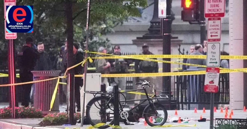 Heavily armed Secret Service tactical agents move across the White House lawn with rifles drawn.
