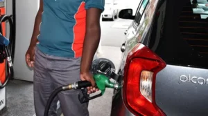 Petrol pump nozzle filling a car as South Africa faces a massive fuel price hike.