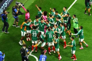 Mexico players celebrate after beating Ecuador 2-0 to reach World Cup Round of 16 at Azteca.