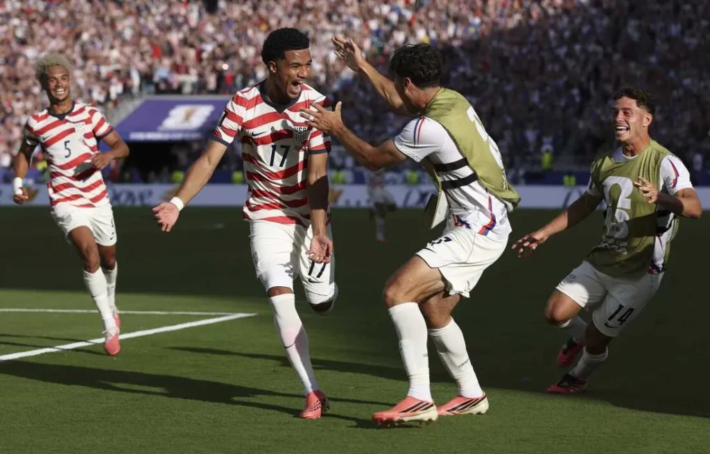USA celebrates 2-0 win over Bosnia to reach FIFA World Cup 2026 Round of 16 despite Balogun red card.